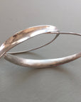 Minimal silver loop earrings.
