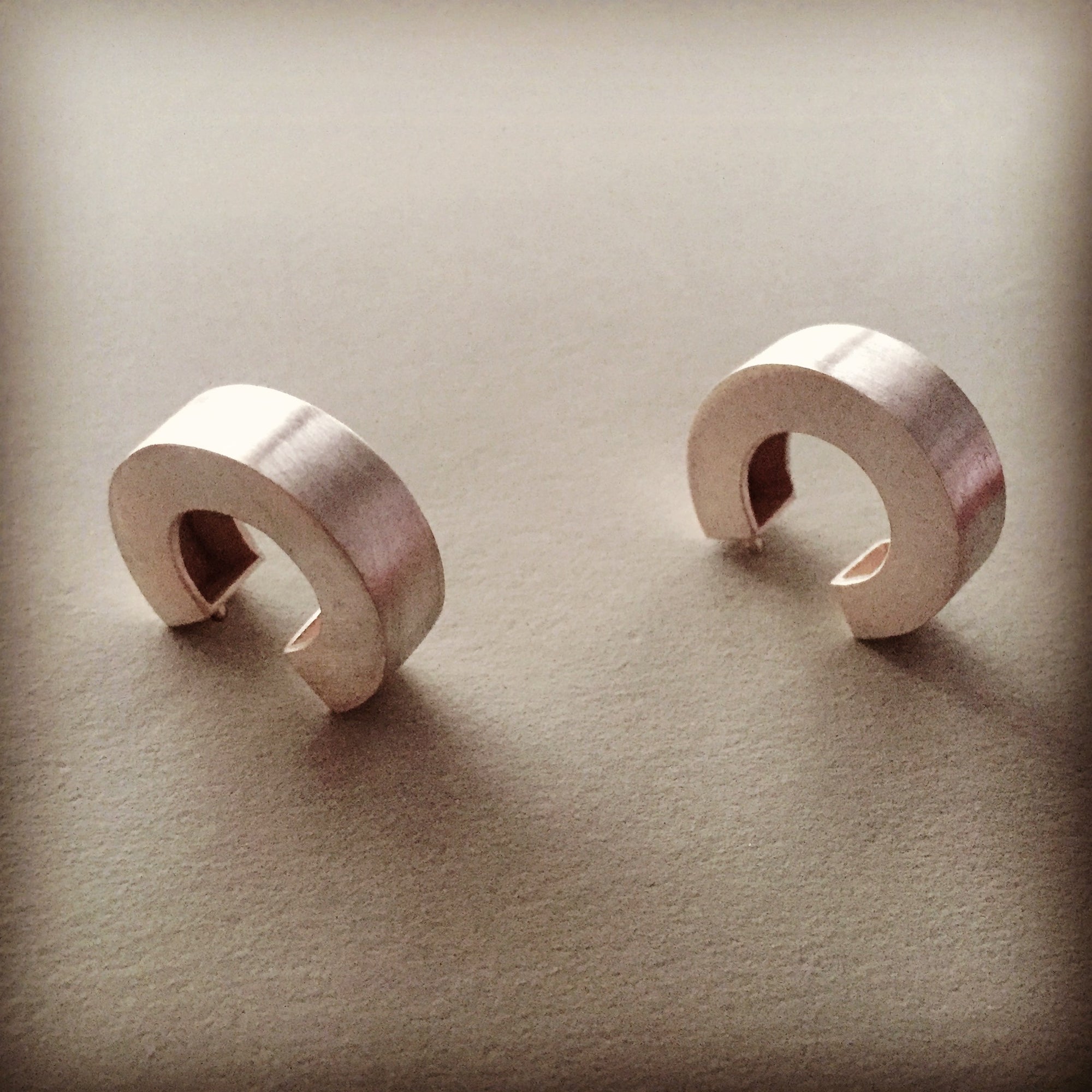 Chunky silver hoop earrings.