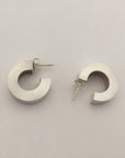 Chunky silver hoop earrings.