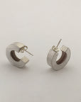 Chunky silver hoop earrings.