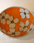 White Porcelain Bowl With Textured Exterior And Orange Inside With White Flowers
