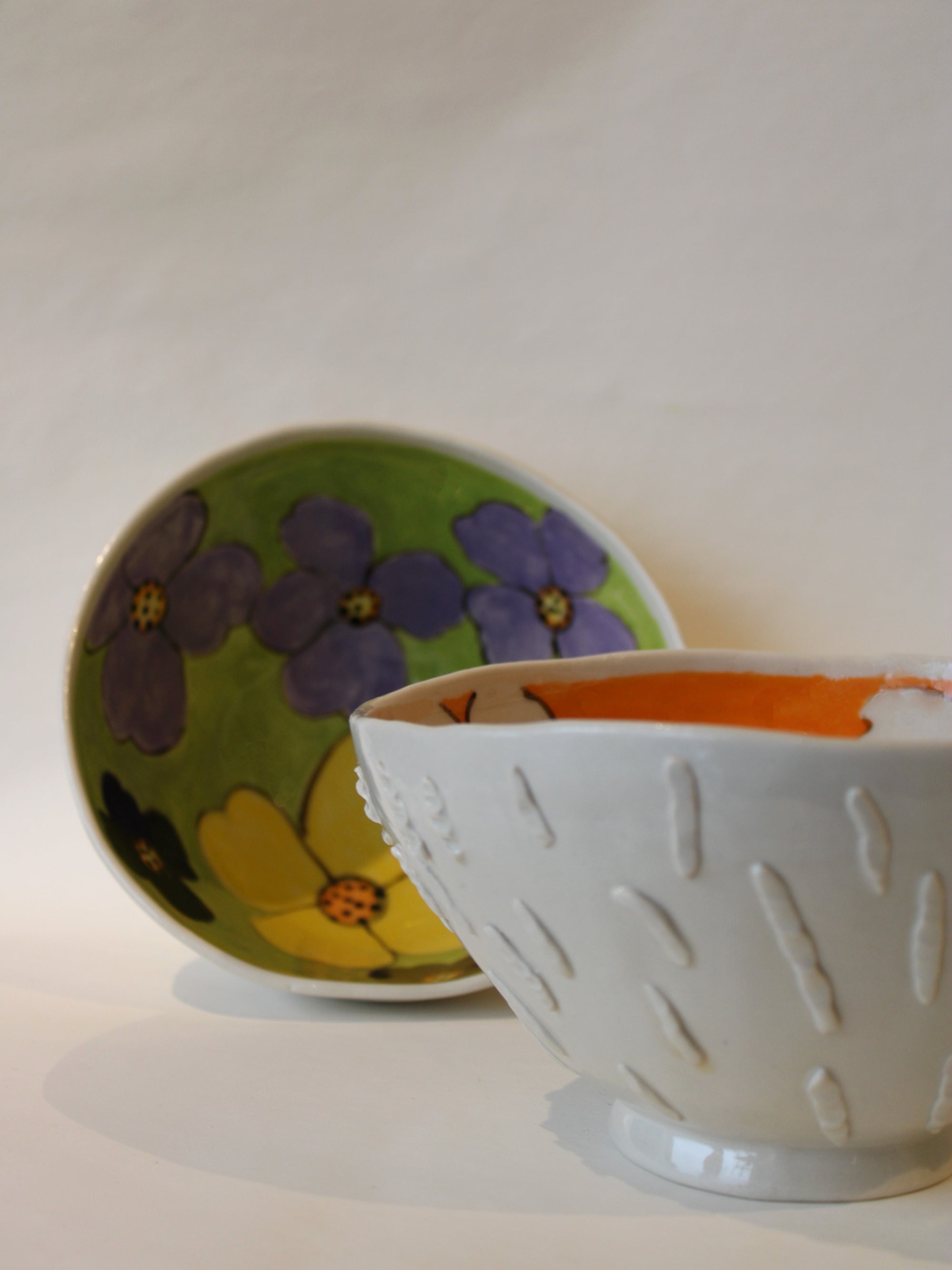 White Porcelain Bowl With Textured Exterior And Orange Inside With White Flowers