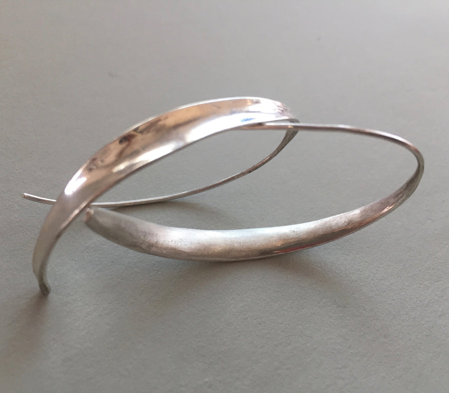 Minimal silver loop earrings.