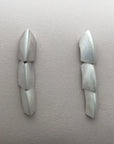 Silver dangle earrings made of 3 scale like pieces.