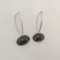 Drop earrings with black oval at the bottom.