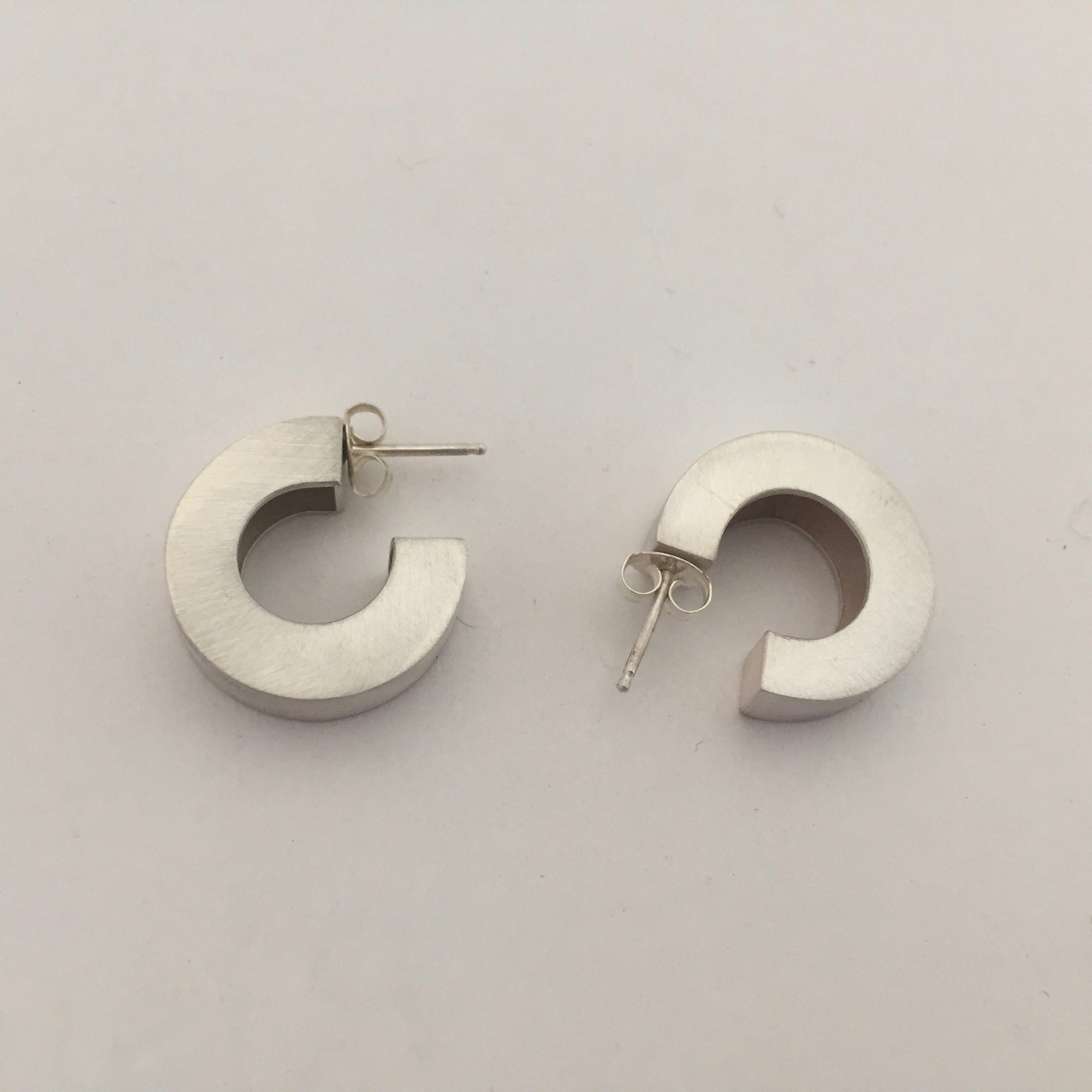 Chunky silver hoop earrings.